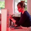 user touching the remote of the rojo red light therapy product